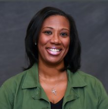 President Coleman is pictured in a green shirt with a gray background.